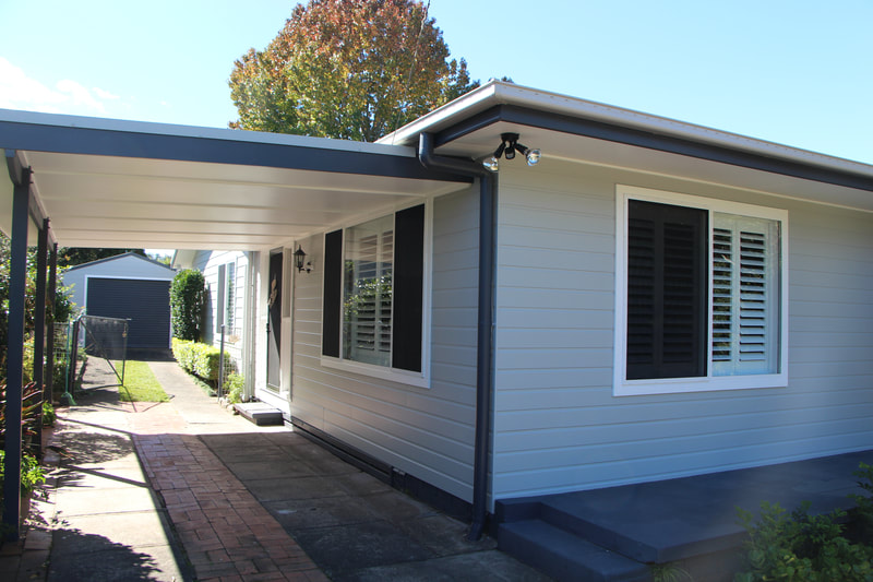 Newly painted exterior of a house: walls, window trims, facia at Lisarow.